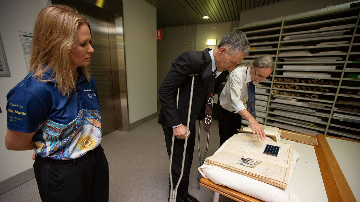 Mel Walley-Stack, Director of AHWA , Minister and Mark Chambers from AHWA looking at historical records.