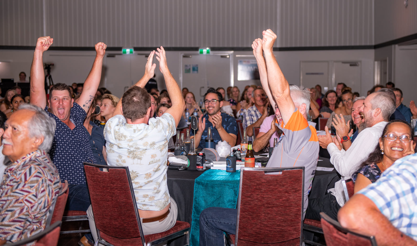 A group of people cheering at a table