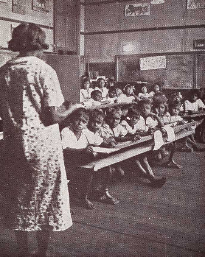 A teacher addressing students in the classroom