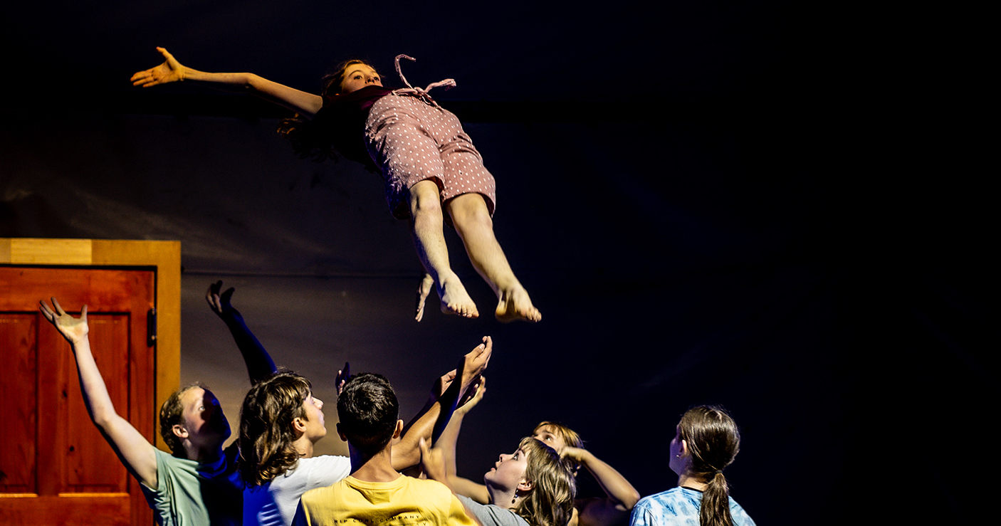 Circus performers throwing a performer in the air