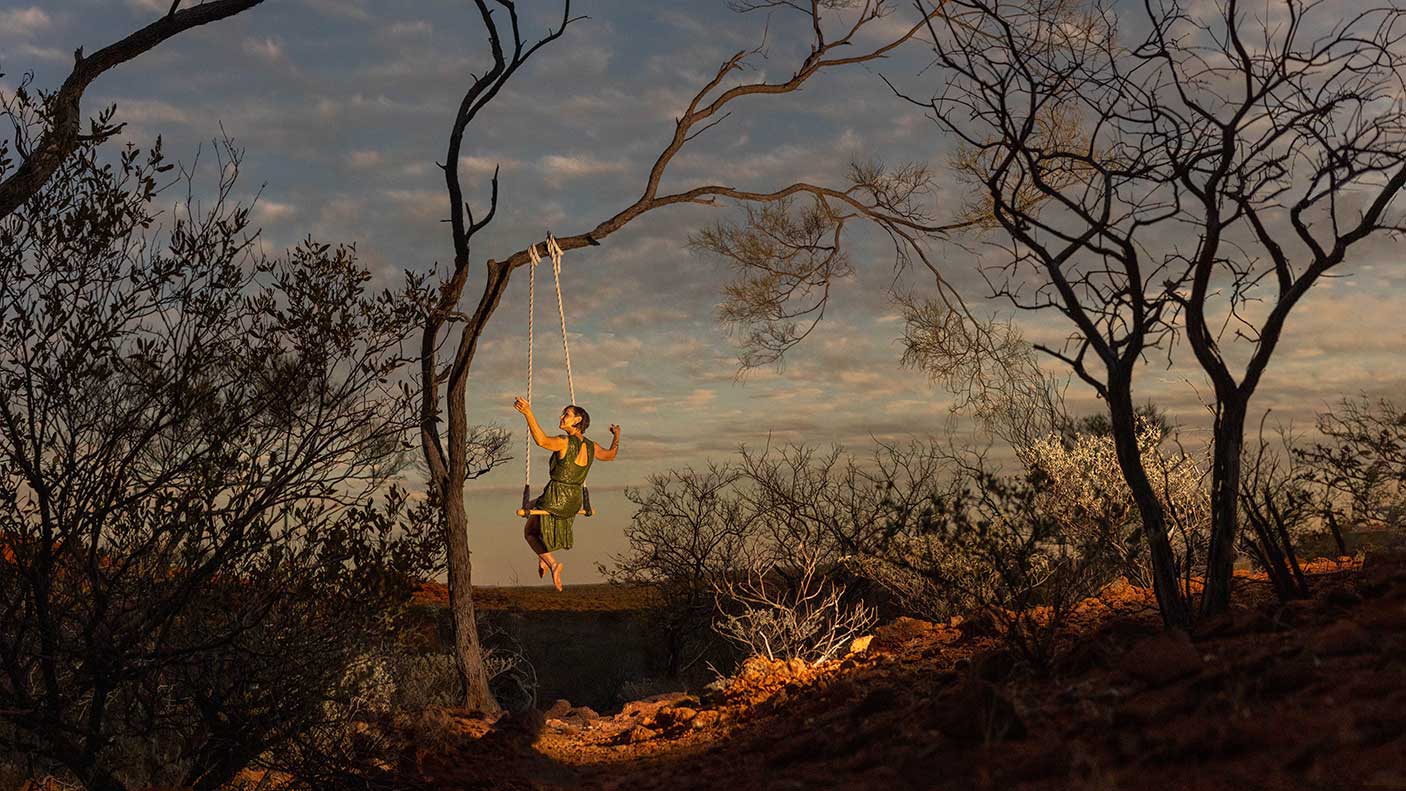 An artist swinging from a tree in regional WA.