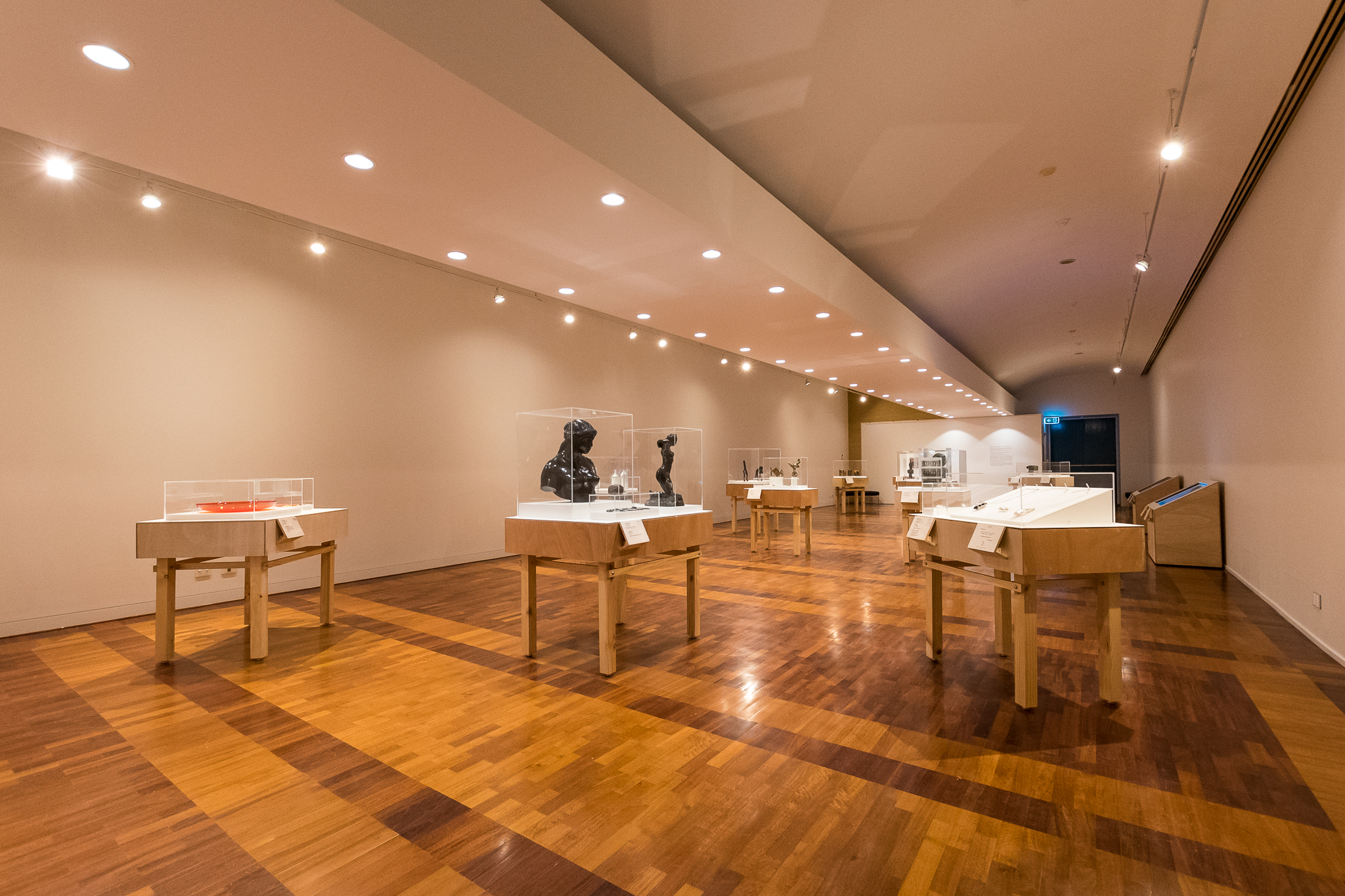 Interior of an art gallery with displays of art pieces.