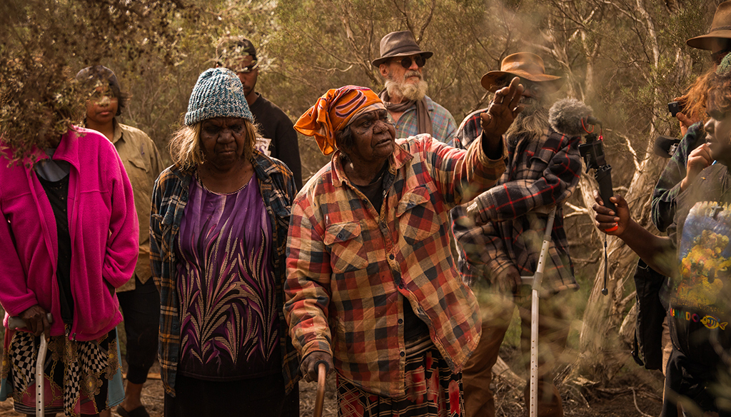 A group of Warlayirti Artists walking on Country