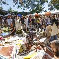 Revealed 2017 Market. Photo by Jessica Wyld. Visitors looking at canvasses on the ground at the market.