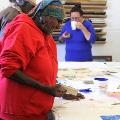 Revealed 2017 Professional Development - Print making. Photo by Jessica Wyld. Aboriginal lady looking at a printing block.