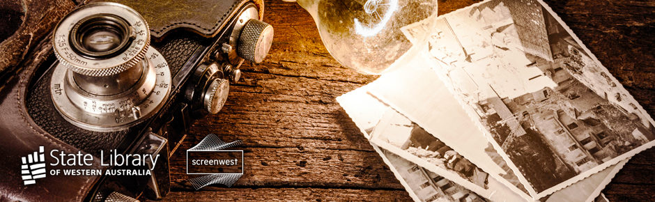 Old camera and photographs on a timber table