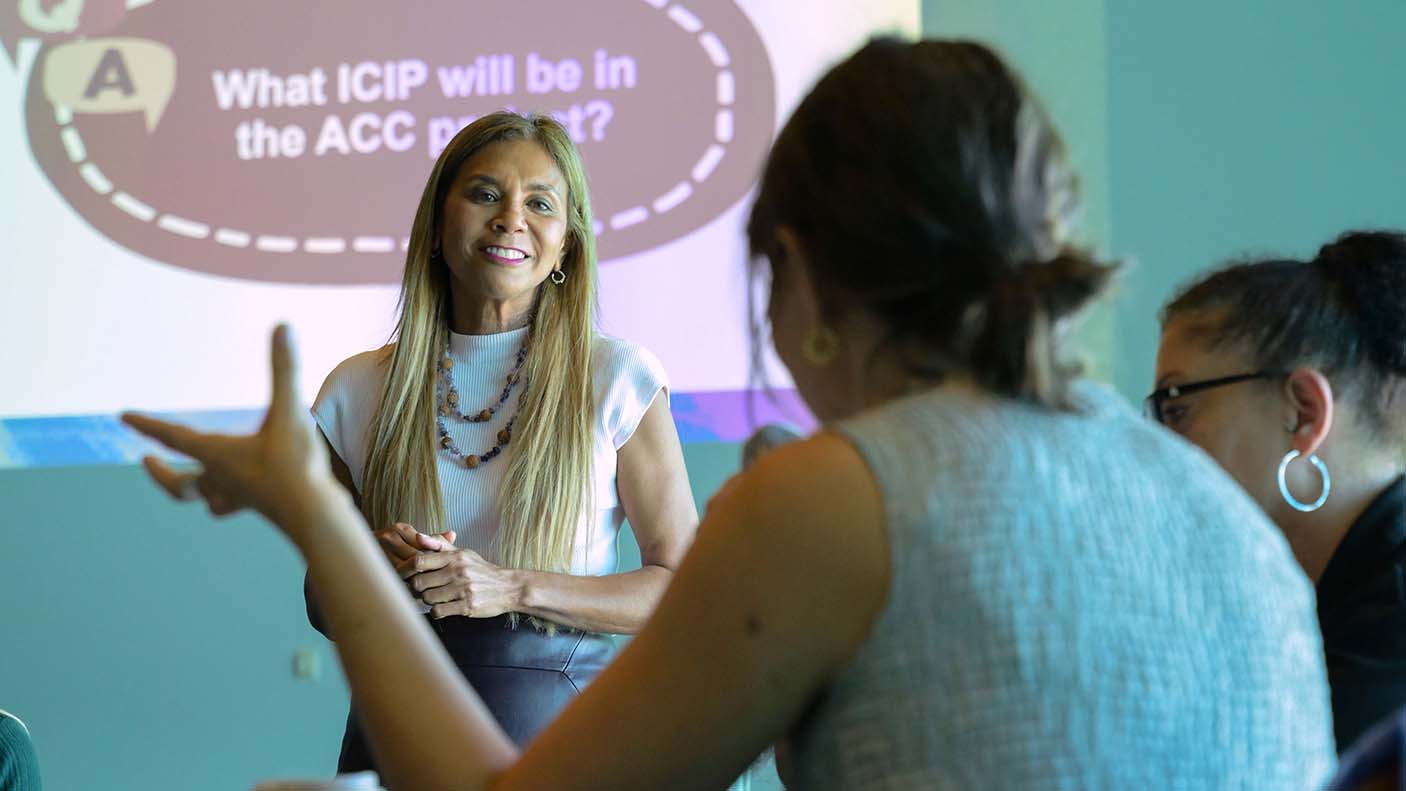 A woman asking a question to a presenter