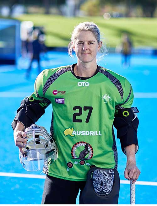 Rachael Lynch standing on a hockey field in uniform