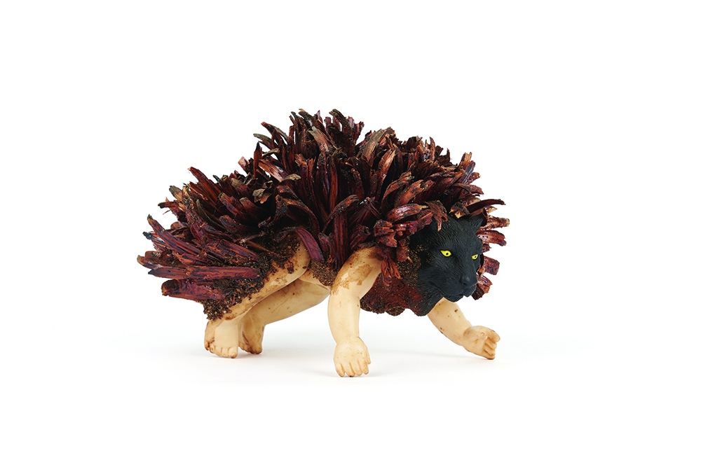 ‘GRRR’, rubber doll body and animal head (both found on roadside, 1990s), Xanthorrhoea bracts, acrylic medium, 16 x 11 x 11 cm. On loan Anne M Brody Collection, Perth. Artist: Nalda Searles. Photographer Rebecca Mansell.