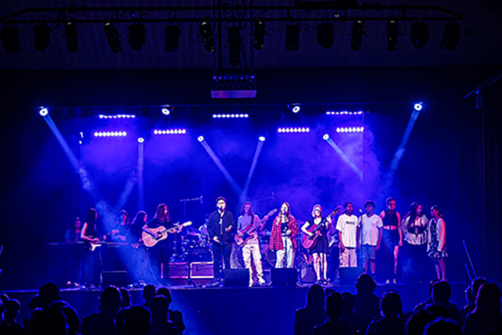 A group of young musicians performing on stage.