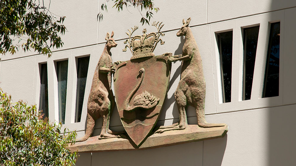 A closeup photo of the WA State Government coat of arms on Parliament House