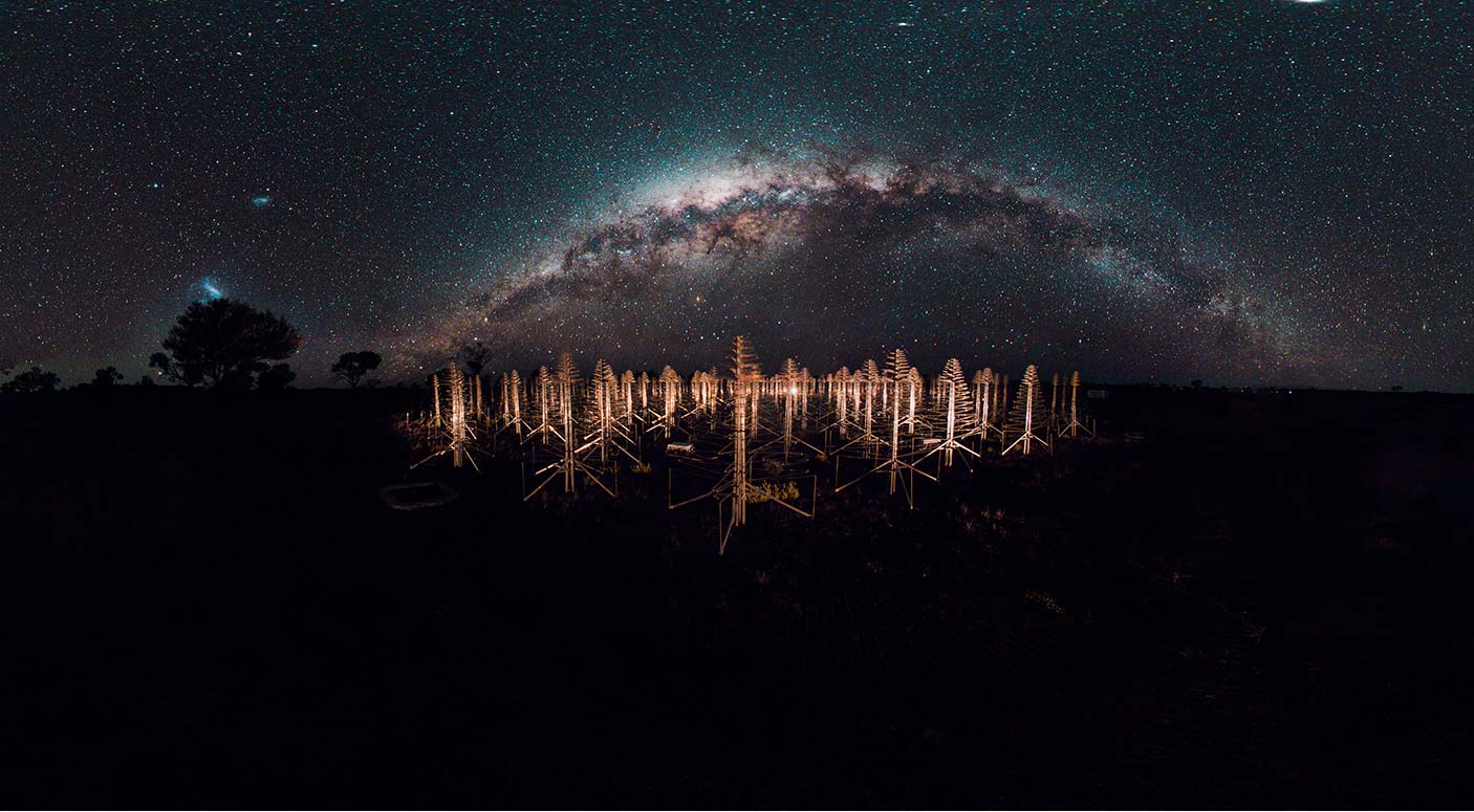 A nightscape of a telescope array with the Milkyway in the sky.