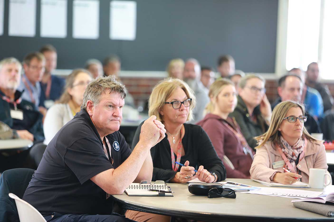 An audience seated listening to someone talk