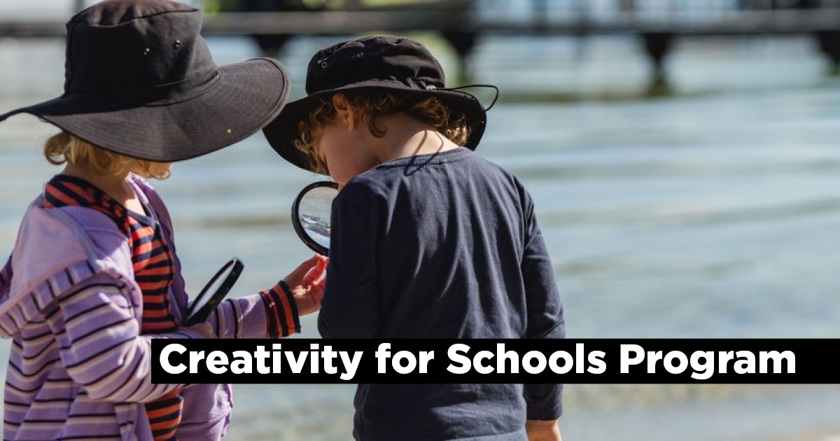 2 students using magnifying glasses at the beach with the words, 'Creativity for Schools Program'