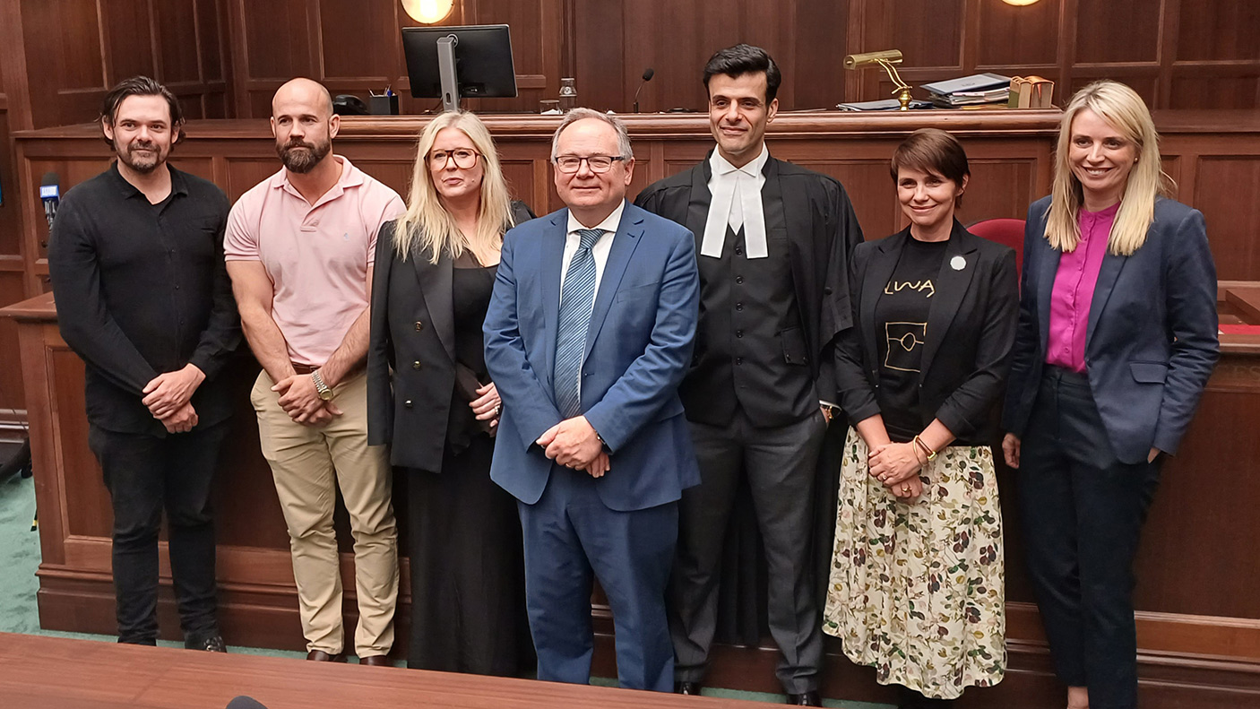 A group of people standing together in a court room