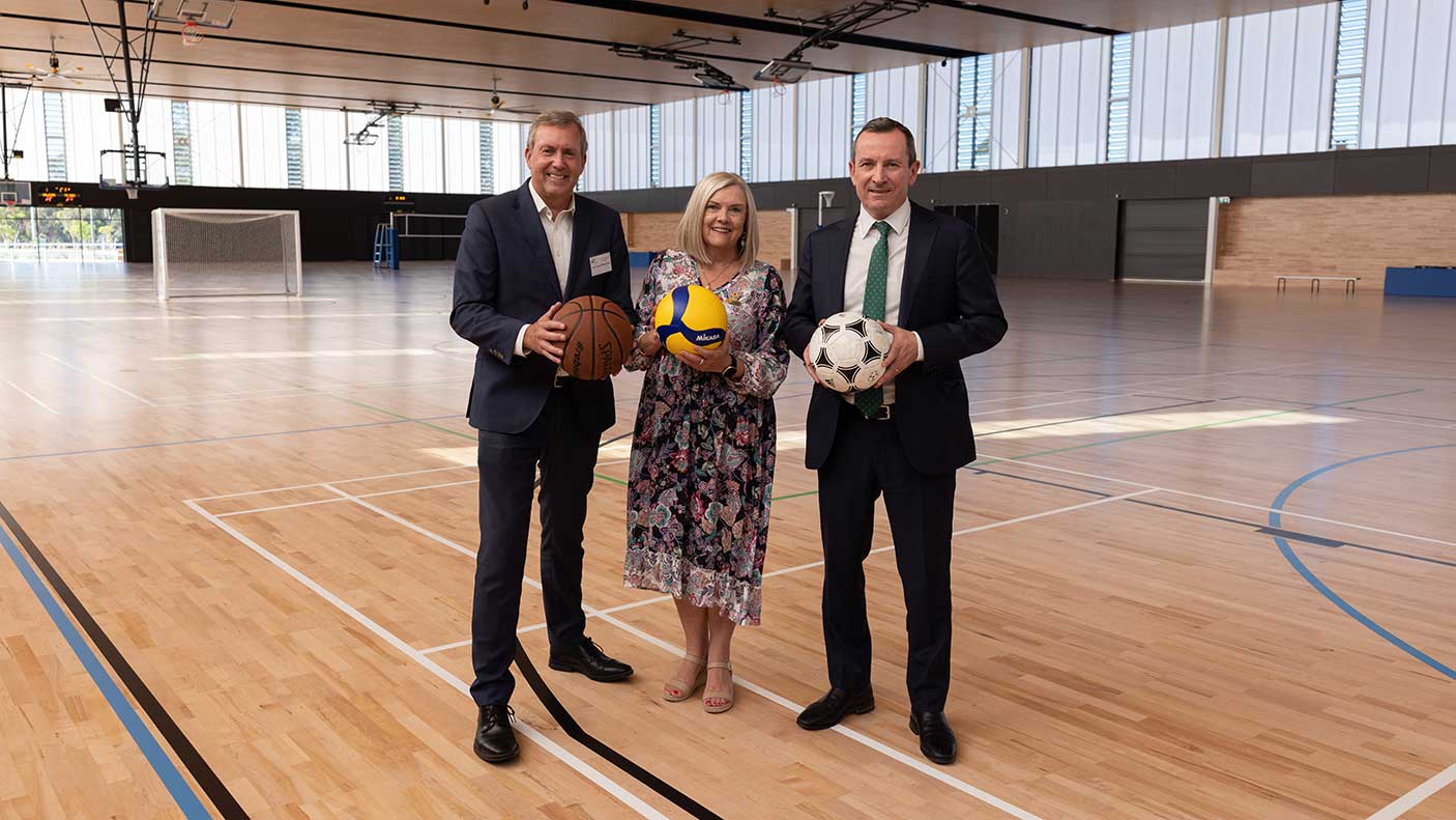 Baldivis MLA Reece Whitby, City of Rockingham Mayor Deb Hamblin and Premier and Rockingham MLA Mark McGowan standing on the new indoor court holding sports balls.