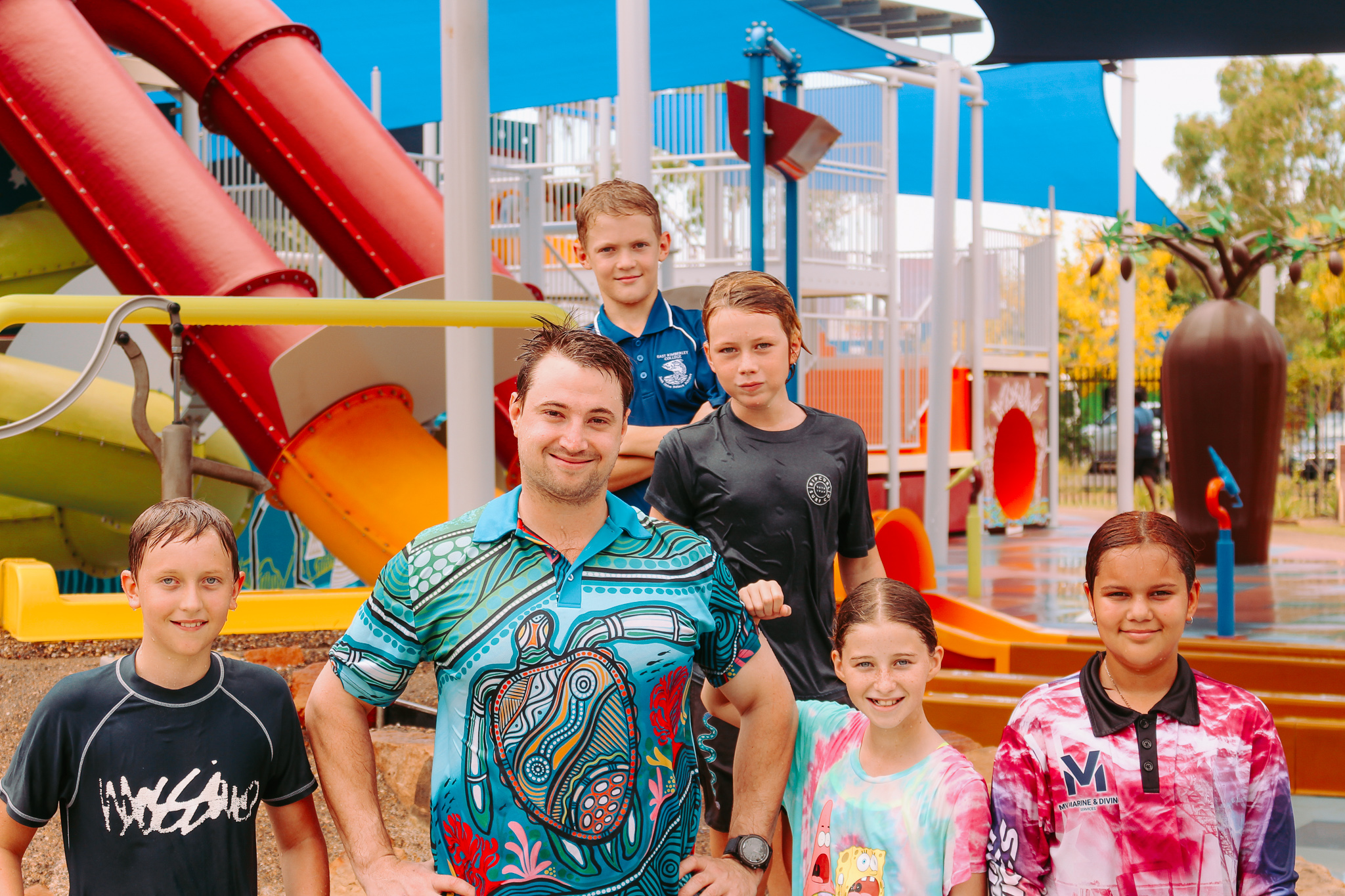 A man with kids at an aquatic facility