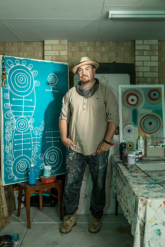 WA Aboriginal artist, Tee Jay Worrigal with his artwork