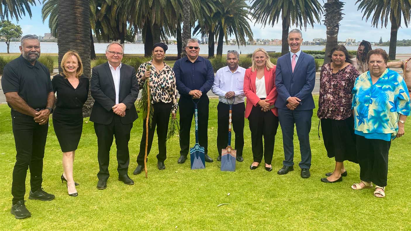 A group of people standing together on the site where the Aboriginal Cultural Centre will be.