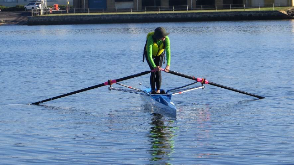 A person rowing while standing up