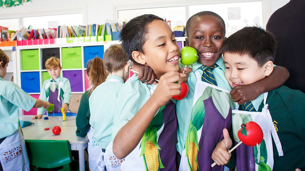 3 students huddled together in an art class