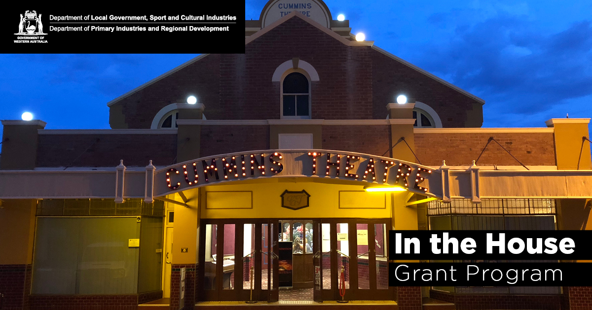 An exterior of a theatre lit up early evening.