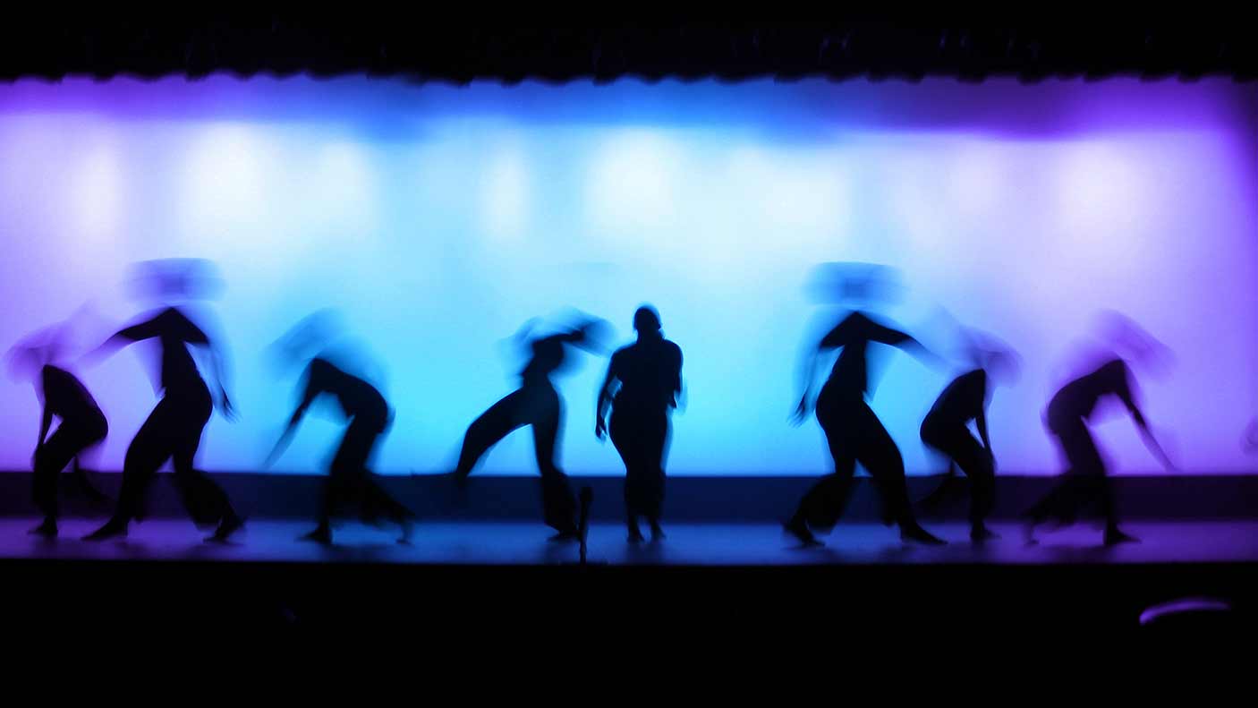 Shot of performers on stage with lights in the background