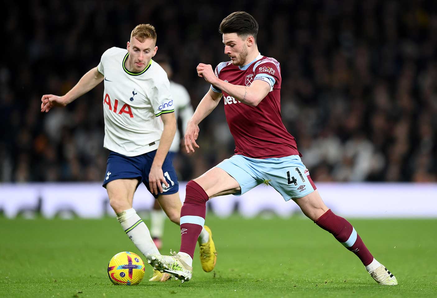 Two professional football players playing a Premier League game.