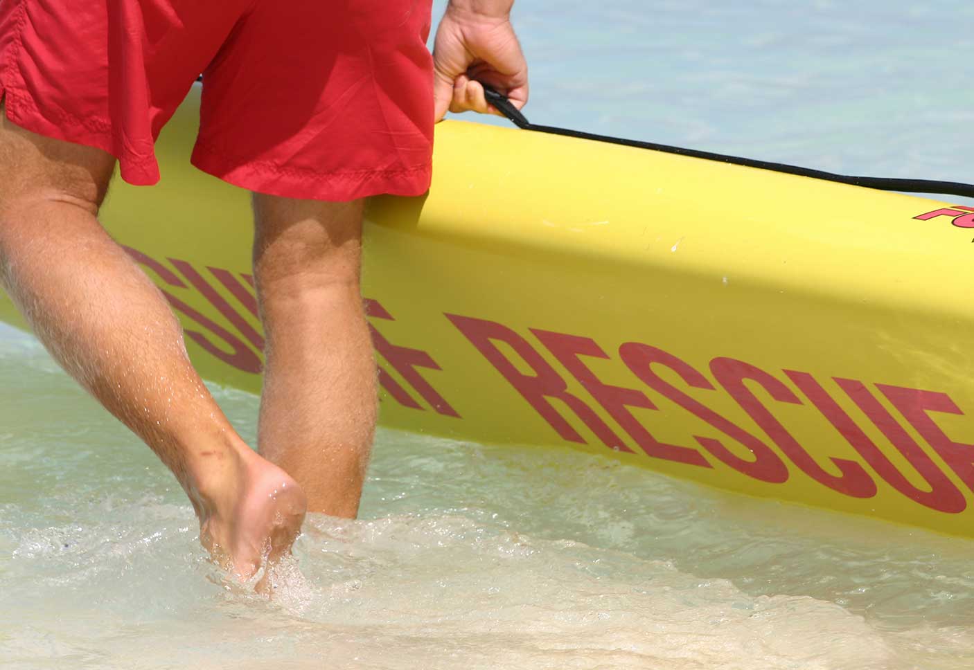 A life guard entering the ocean