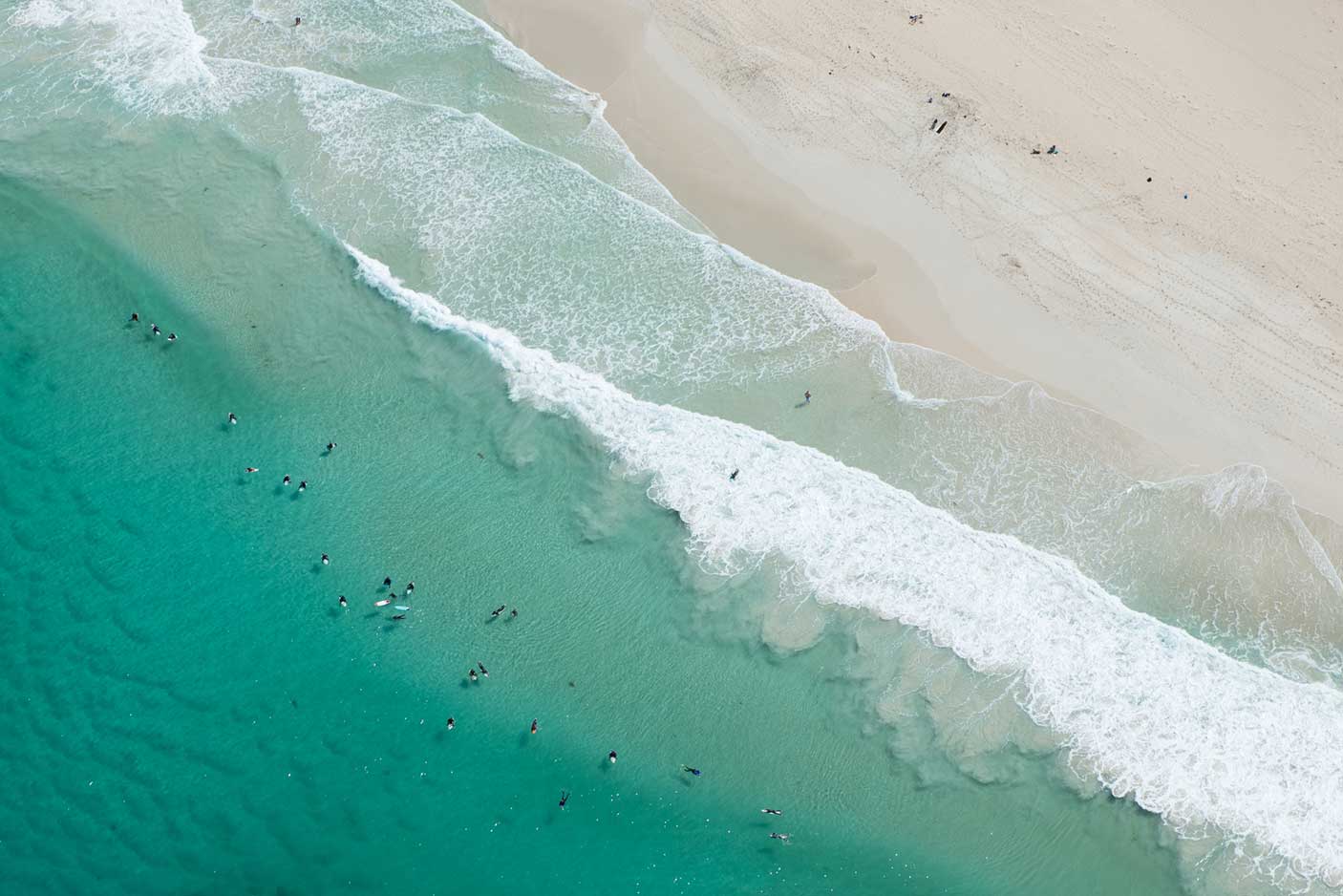 Surfers in the surf from above