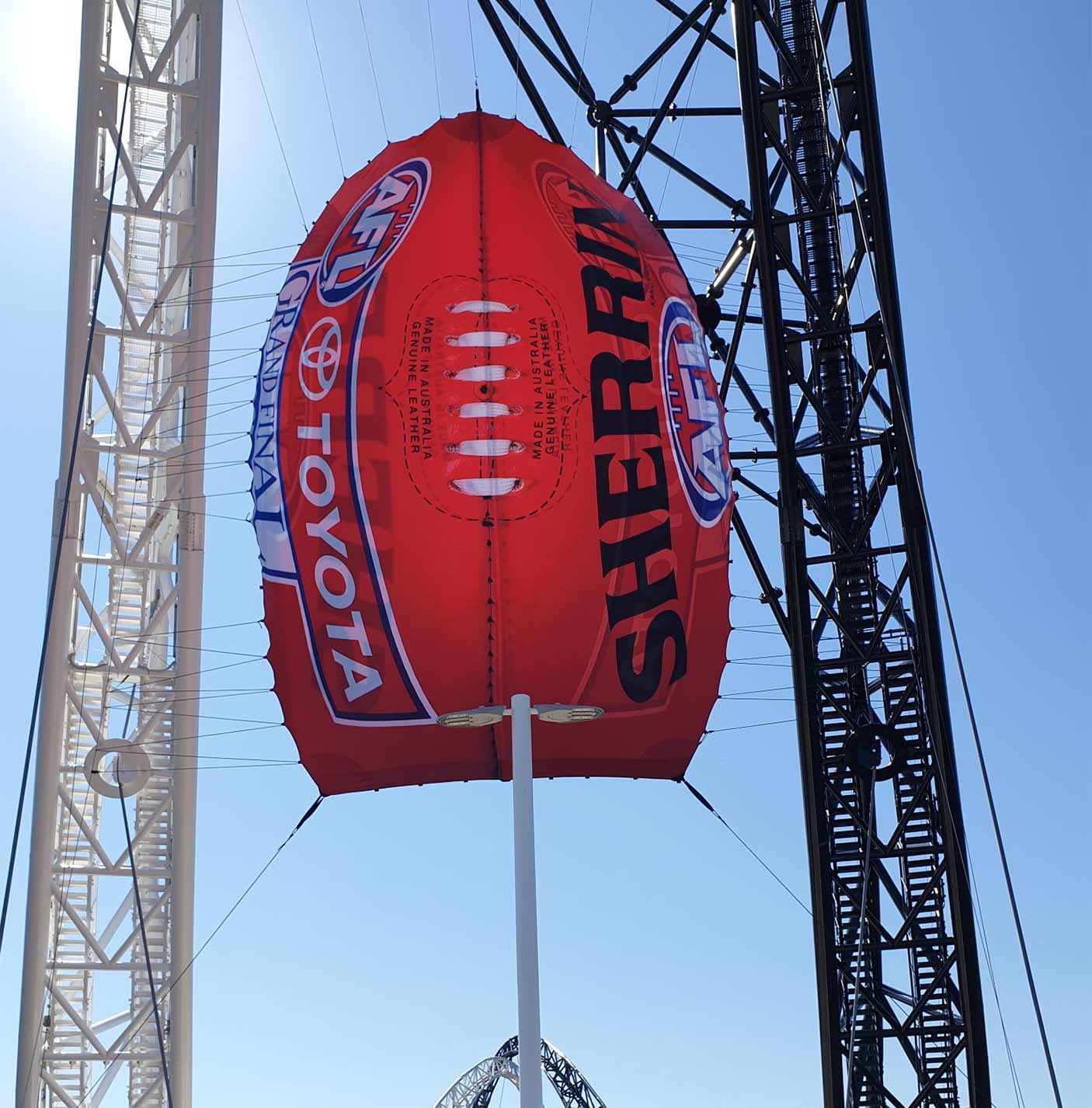 Giant AFL Sherrin football banner displayed on Matagarup Bridge