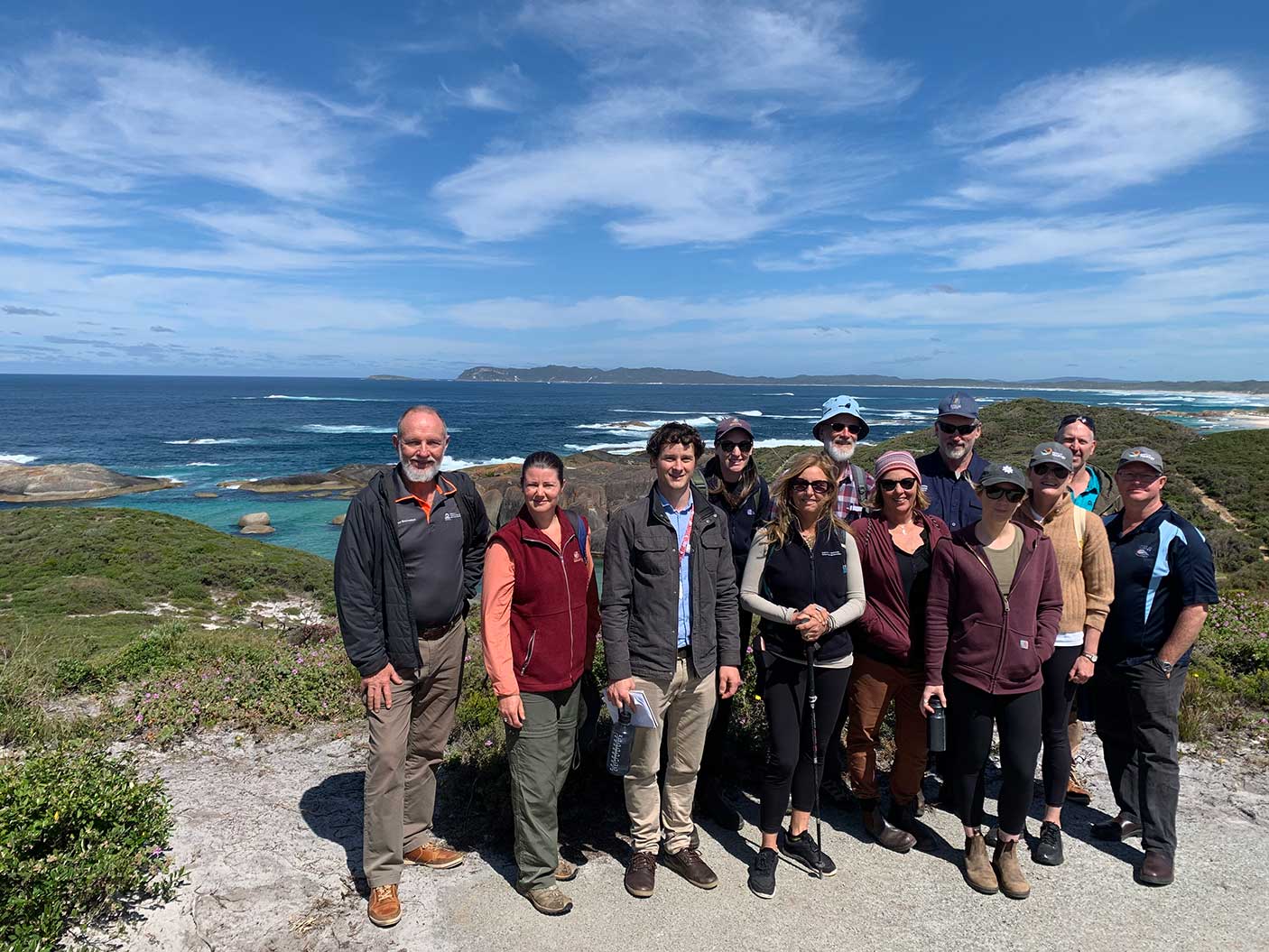 A group of people with the ocean behind them