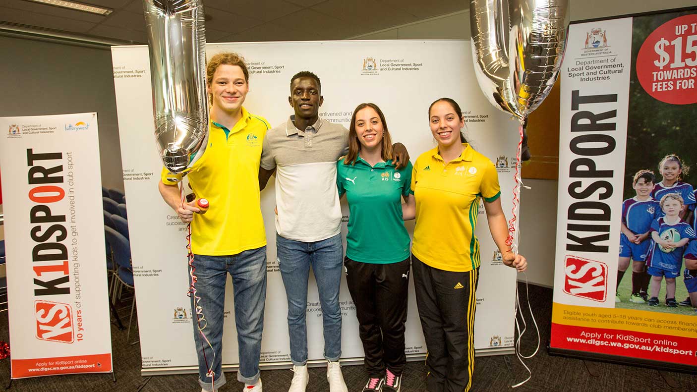 A group of athletes holding balloons for the KidSport 10 year anniversary