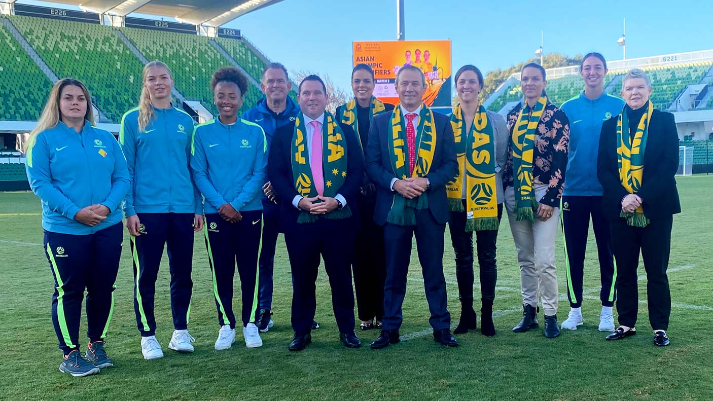 A group of people either wearing exercise clothes or suits with Matilda scarves.