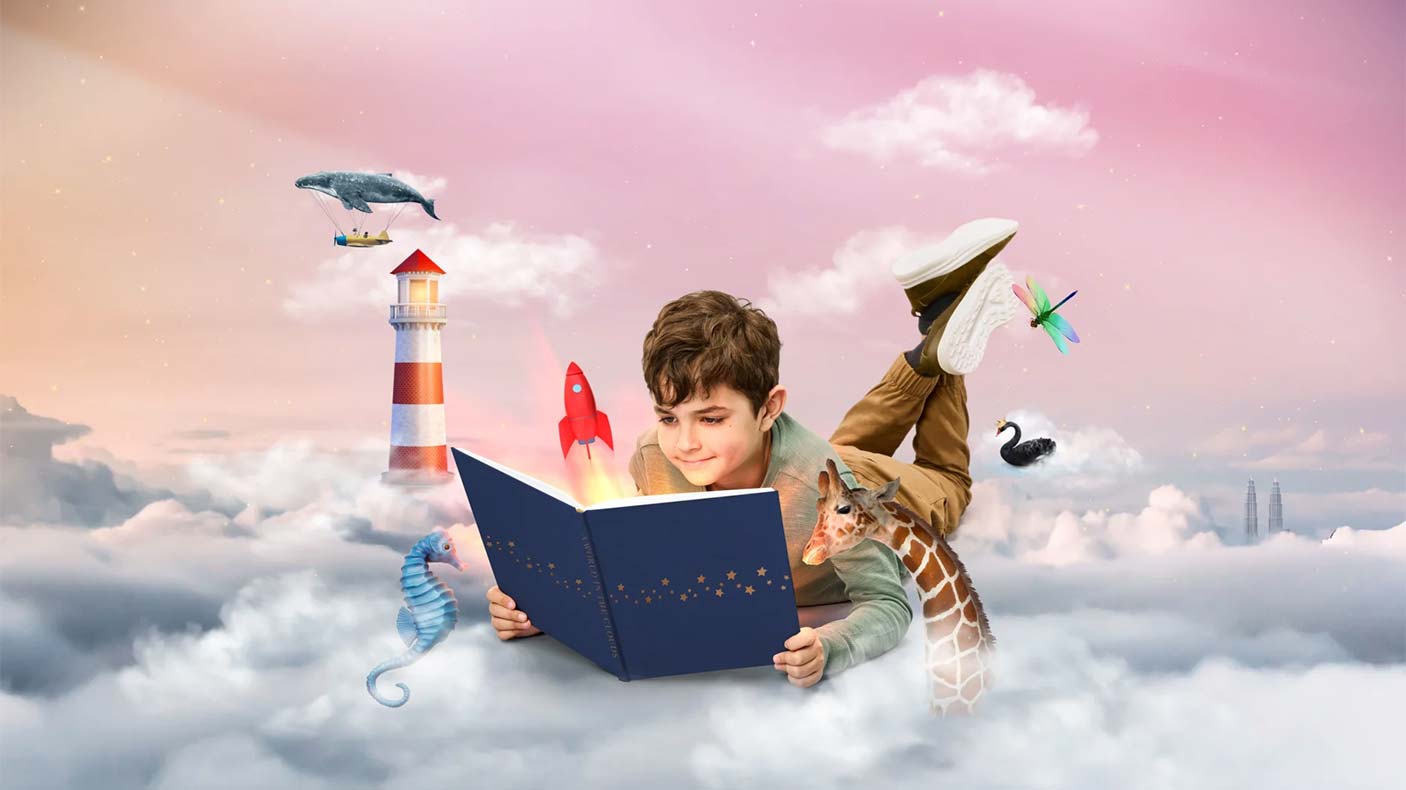 An illustration of a boy reading in the clouds with animals, a lighthouse and  a rocket around him to show imagination.