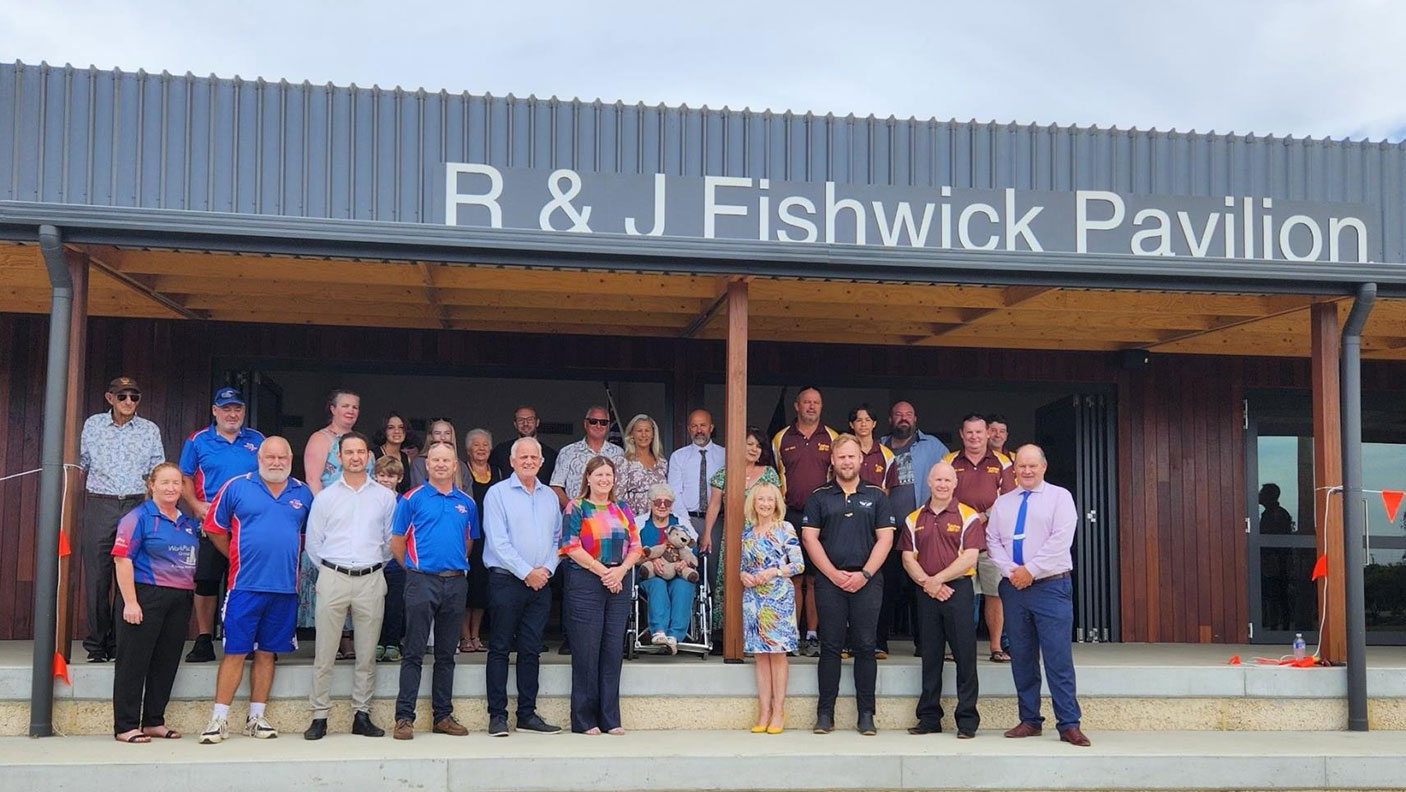 Attendees stand on the verandah at the opening of the R & J FishWick Pavilion