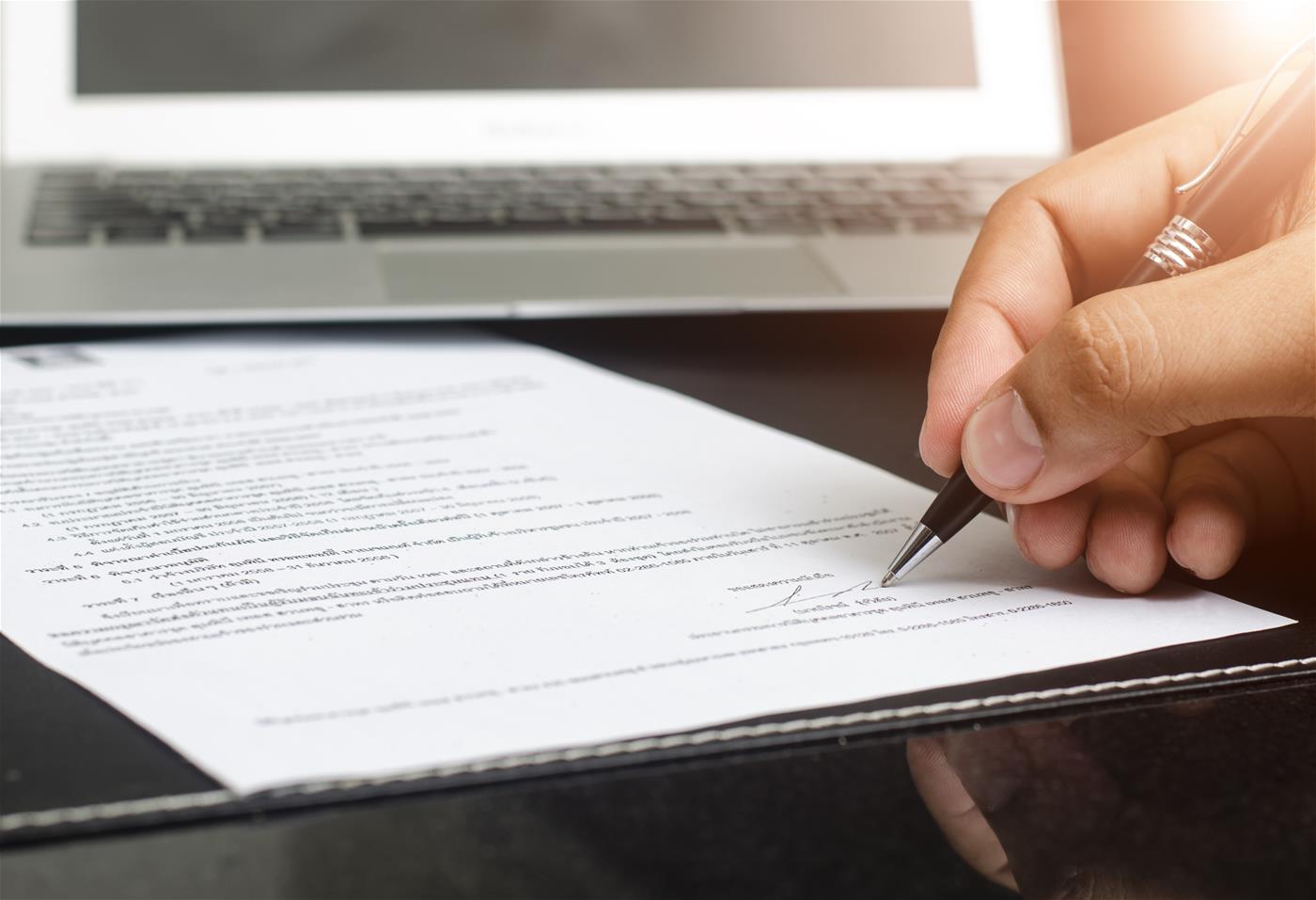 Hand signing a document