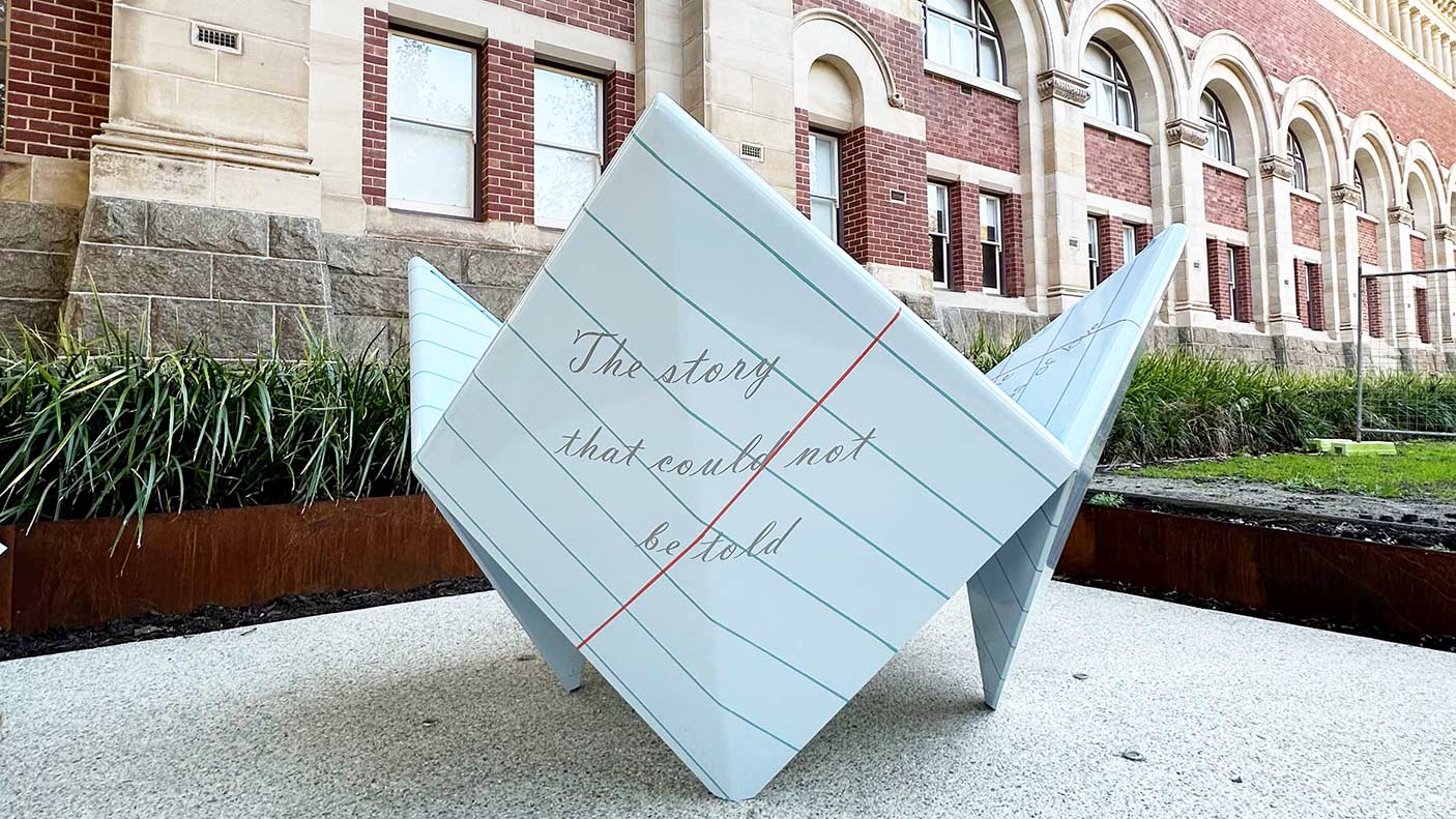 A 'chatterbox' sculpture outside of the WA Museum, Perth. The words, 'The story that could not be told'.