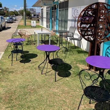 An alfresco area with tables and chairs on a lawn