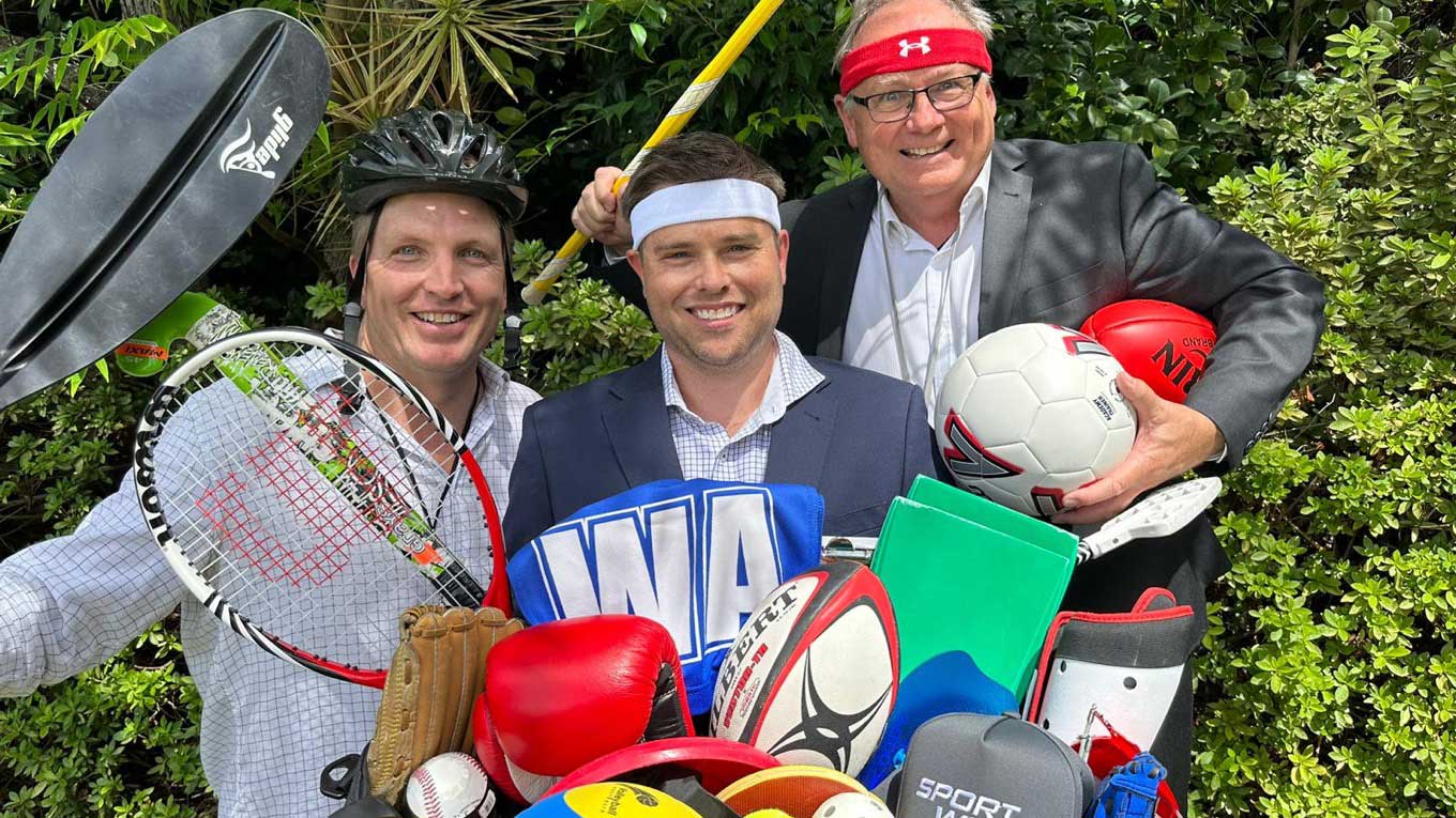 Matt Hayes, Matt Fulton and Minister Templeman posing with sports equipment.