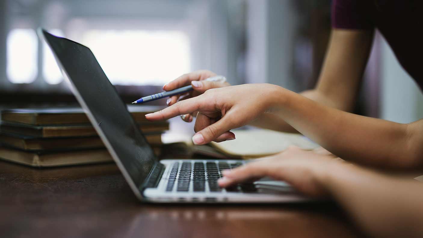 Two people working on a computer.