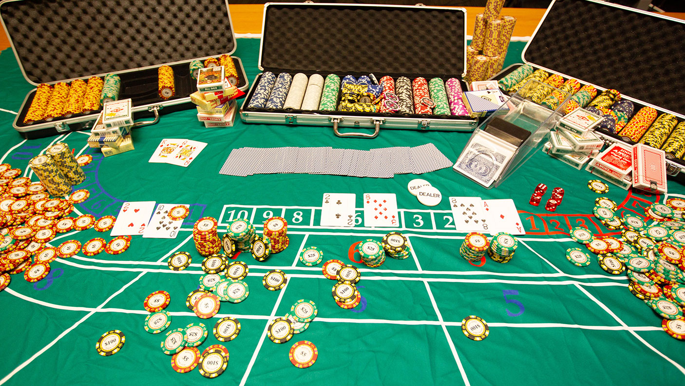 A gaming table with gambling chips and  playingcards