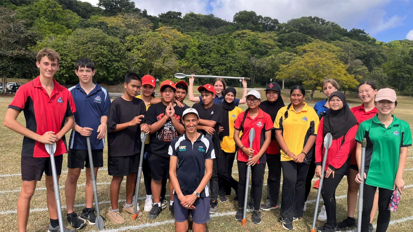 Students from Christmas Island High School stand with olympian Kylie Wheeler