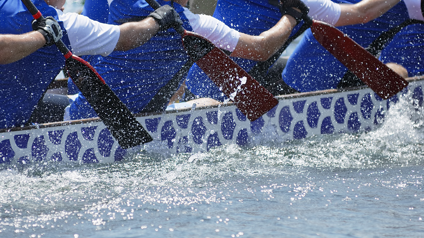 Close up of 4 people rowing.