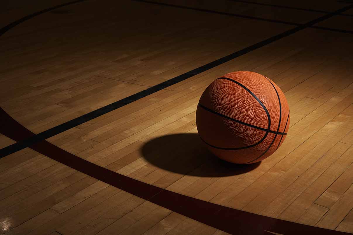 Stock image of a basketball on a court. Getty Images.