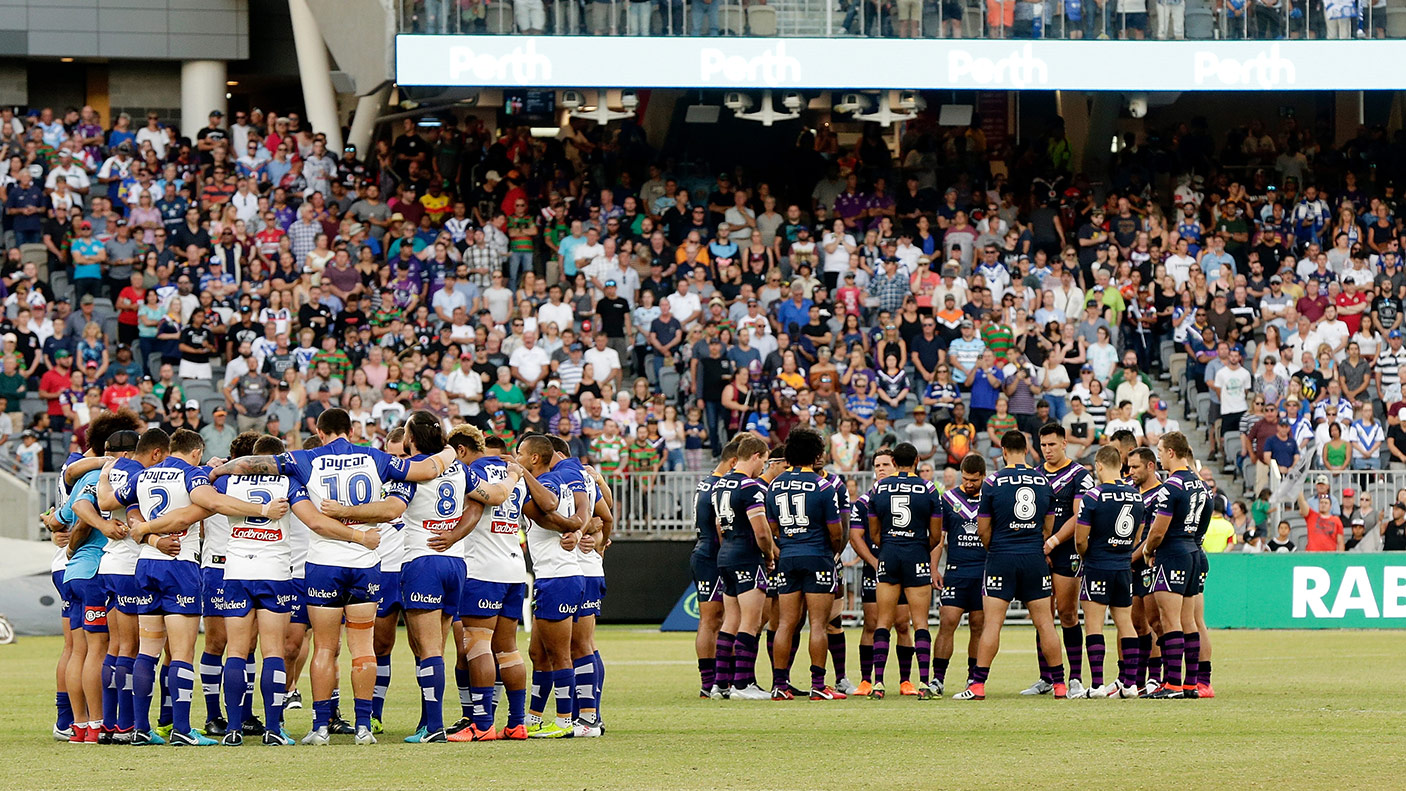 The Bulldogs and Storm players form a huddle in memory of Steve Folkes during the round one NRL match between the Canterbury Bulldogs and the Melbourne Storm at Perth Stadium on March 10, 2018 in Perth, Australia. (Photo by Will Russell/Getty Images)