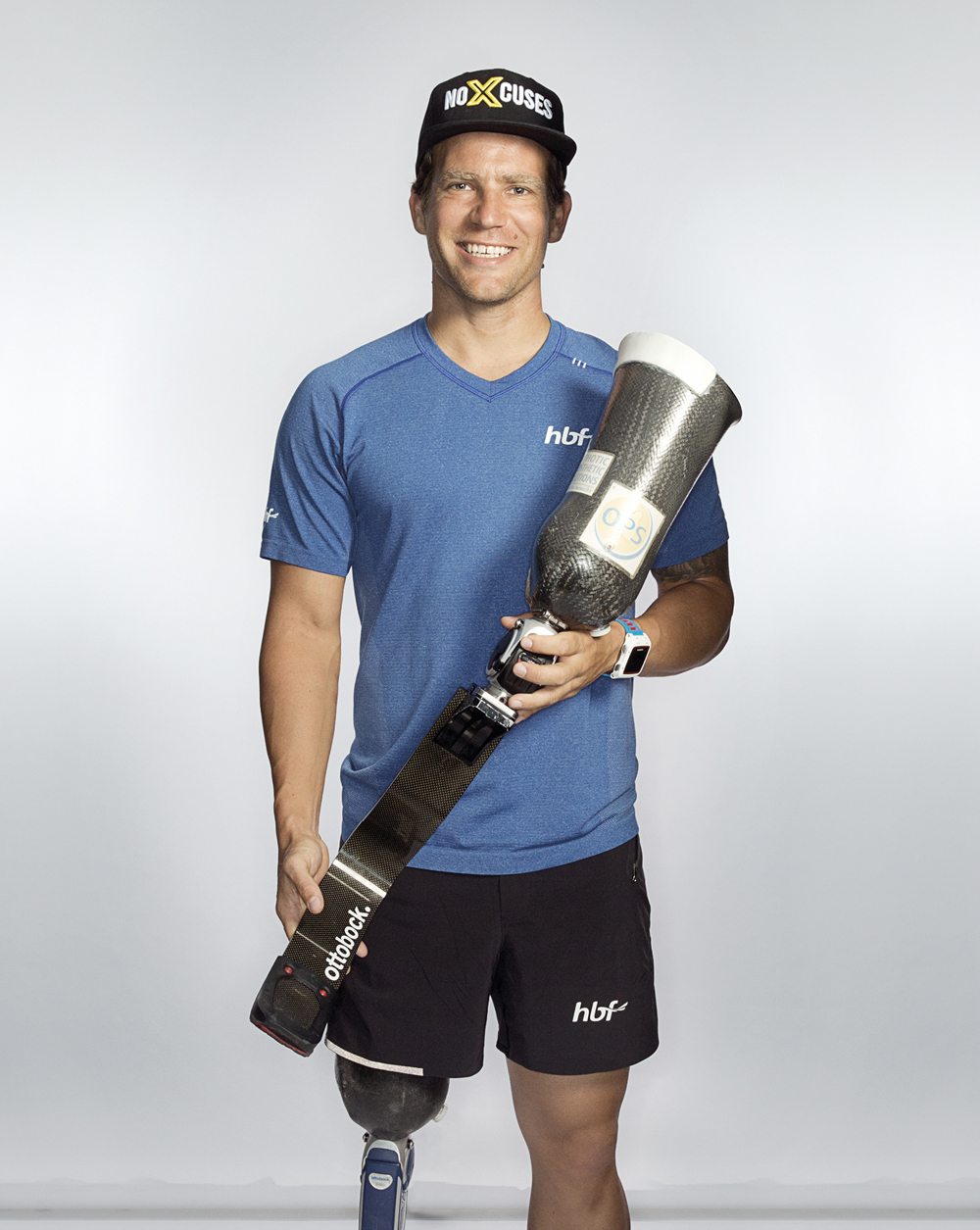 Portrait of Brant Garvey holding a prosthetic leg