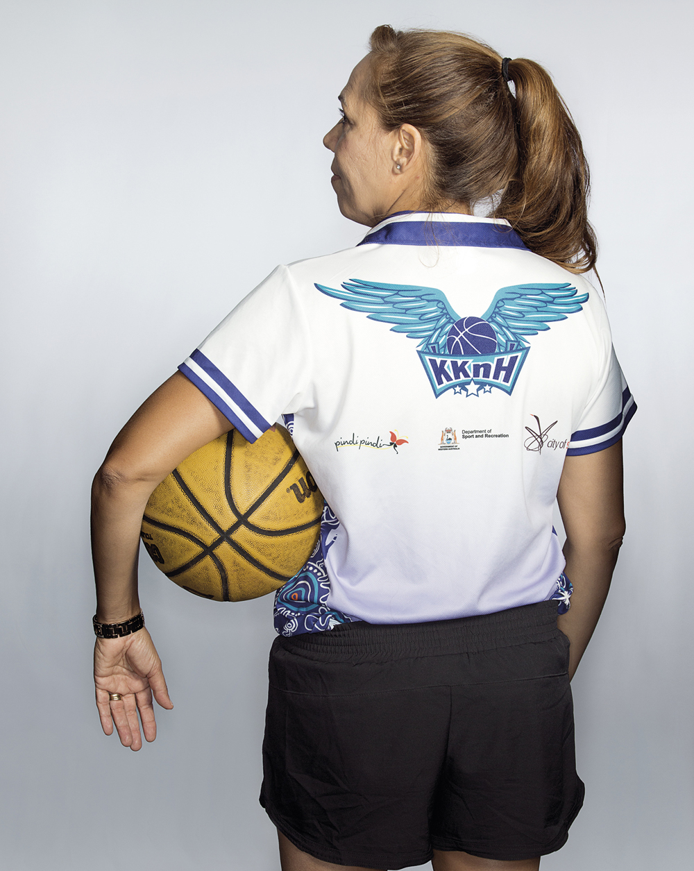 Portrait of Cheryl Tucker-Kickett holding a basketball