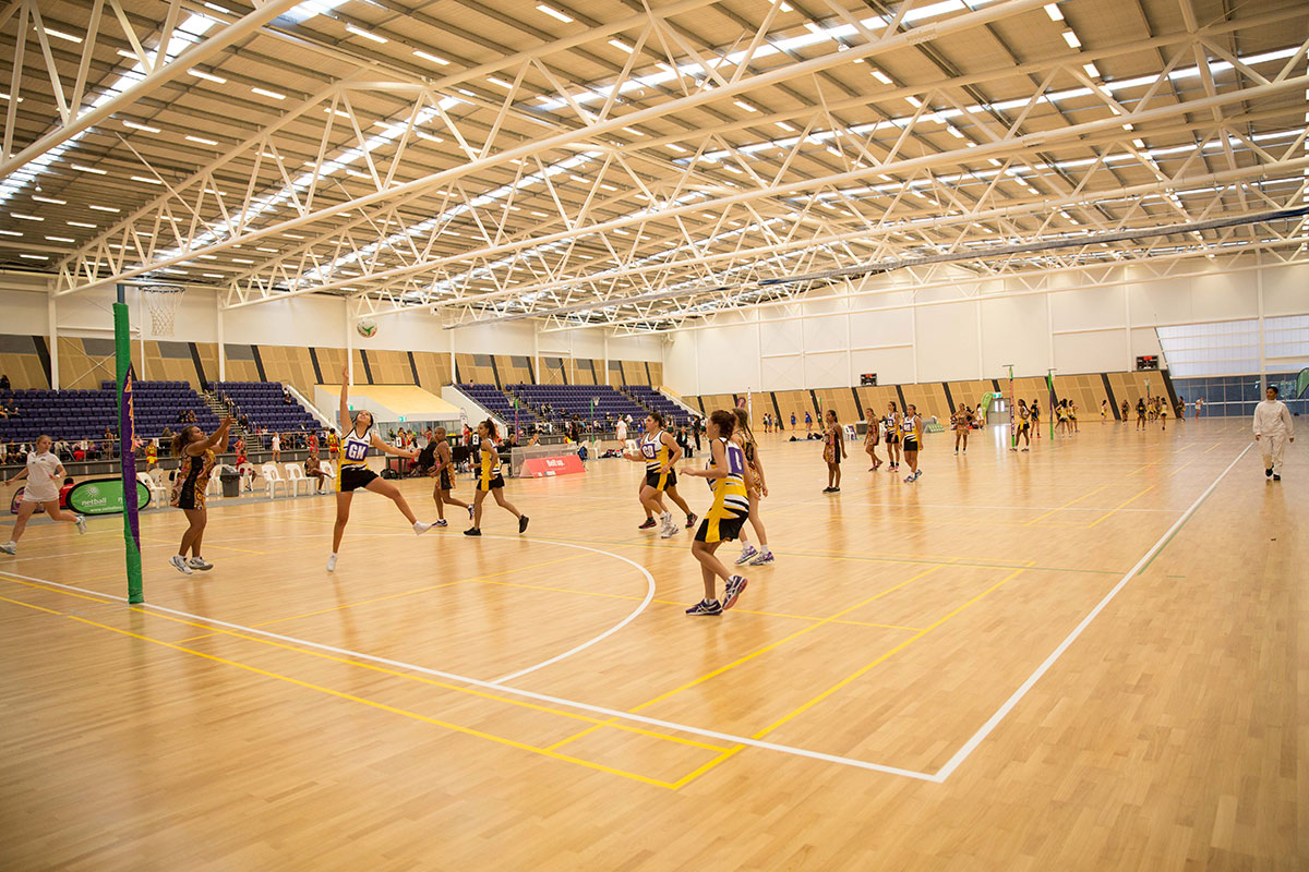 Netball players on court at the State Netball Centre during NAIDOC Week 2015