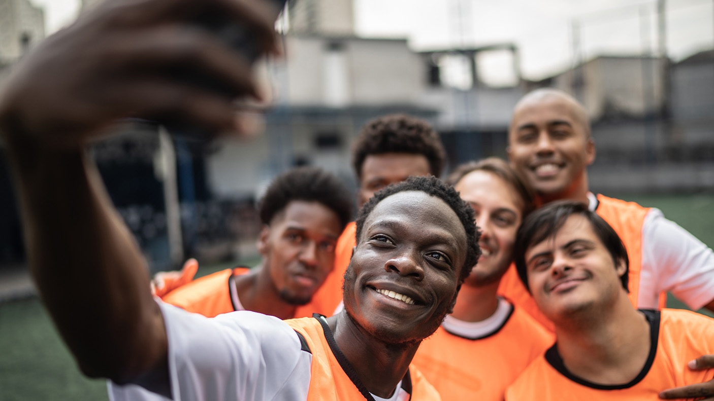 A  sporting team pose for a selfie